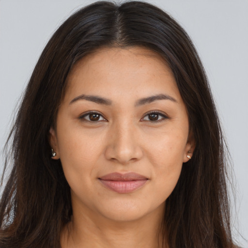 Joyful latino young-adult female with long  brown hair and brown eyes