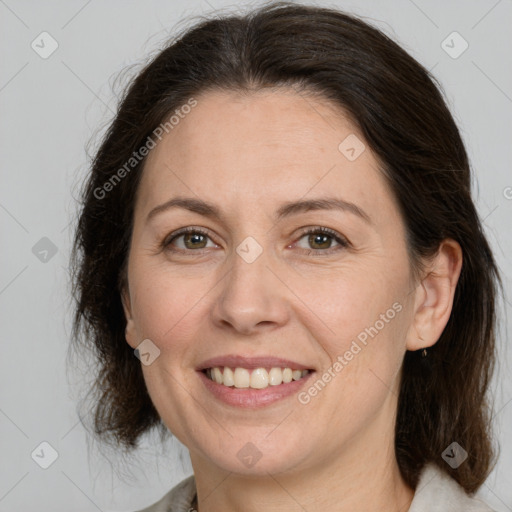 Joyful white adult female with medium  brown hair and brown eyes