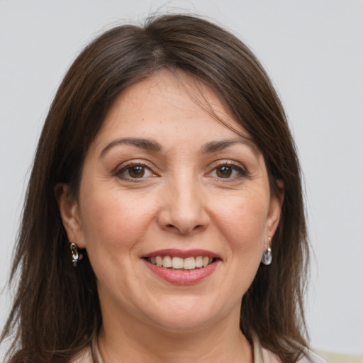 Joyful white adult female with medium  brown hair and grey eyes