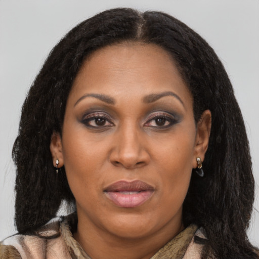 Joyful latino adult female with long  brown hair and brown eyes
