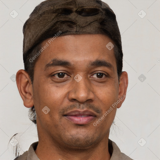 Joyful latino young-adult male with short  brown hair and brown eyes