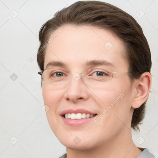 Joyful white young-adult female with medium  brown hair and grey eyes