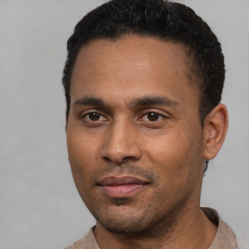 Joyful latino young-adult male with short  black hair and brown eyes
