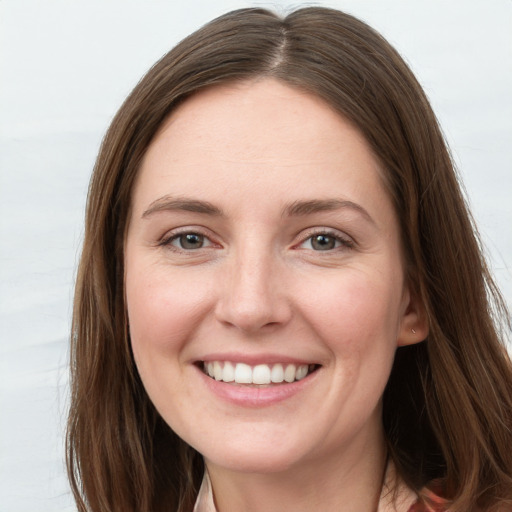 Joyful white young-adult female with long  brown hair and grey eyes