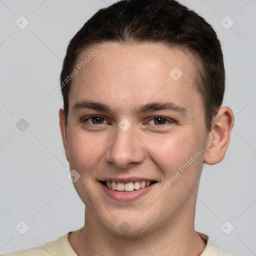 Joyful white young-adult male with short  brown hair and brown eyes