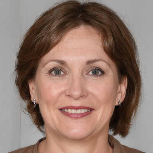 Joyful white adult female with medium  brown hair and brown eyes