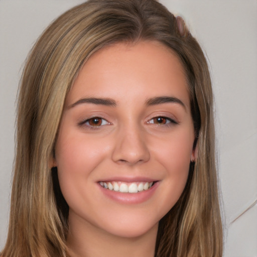 Joyful white young-adult female with long  brown hair and brown eyes