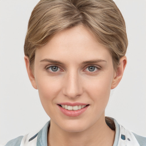 Joyful white young-adult female with short  brown hair and grey eyes