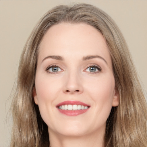 Joyful white young-adult female with long  brown hair and grey eyes