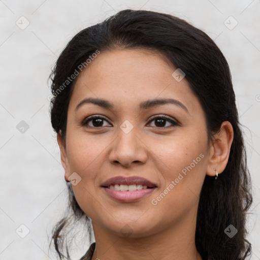 Joyful latino young-adult female with long  brown hair and brown eyes