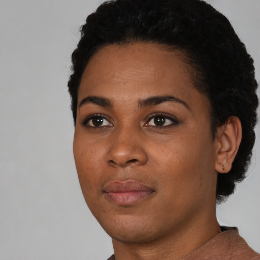 Joyful latino young-adult female with short  black hair and brown eyes