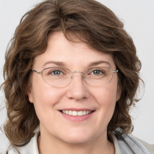 Joyful white adult female with medium  brown hair and grey eyes