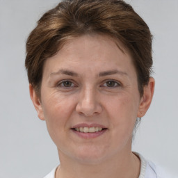 Joyful white adult female with short  brown hair and brown eyes