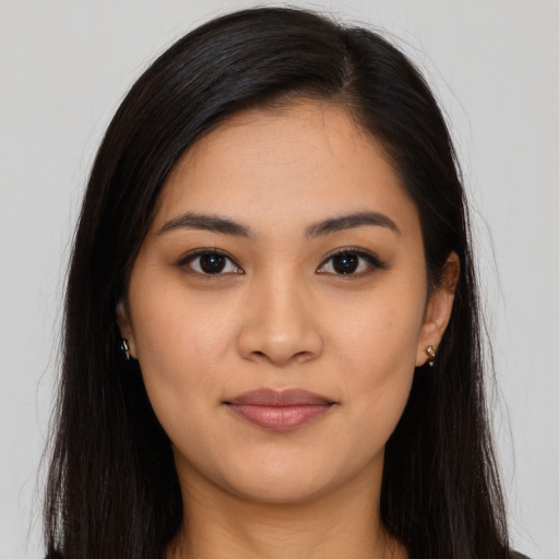 Joyful latino young-adult female with long  brown hair and brown eyes