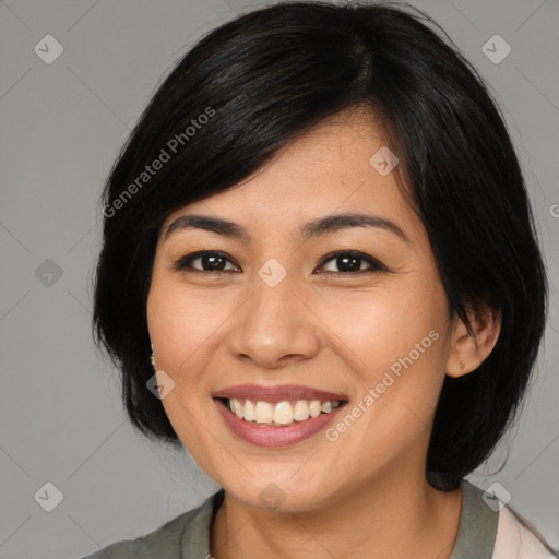 Joyful asian young-adult female with medium  black hair and brown eyes