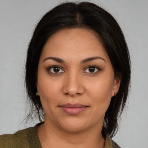 Joyful latino young-adult female with medium  brown hair and brown eyes