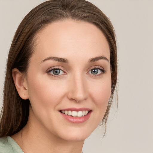 Joyful white young-adult female with medium  brown hair and blue eyes