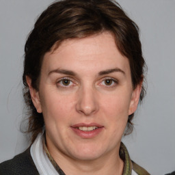 Joyful white adult female with medium  brown hair and brown eyes