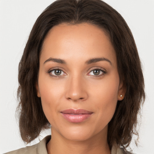 Joyful white young-adult female with long  brown hair and brown eyes