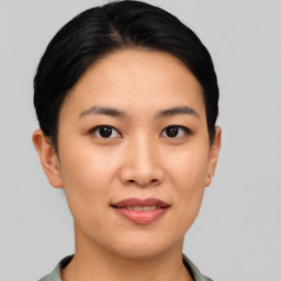 Joyful asian young-adult female with short  black hair and brown eyes