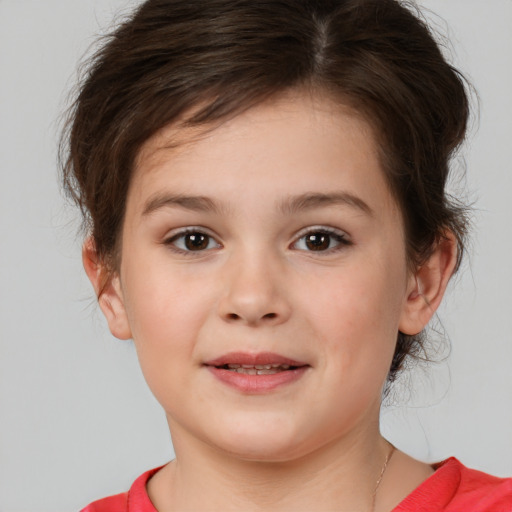 Joyful white child female with medium  brown hair and brown eyes