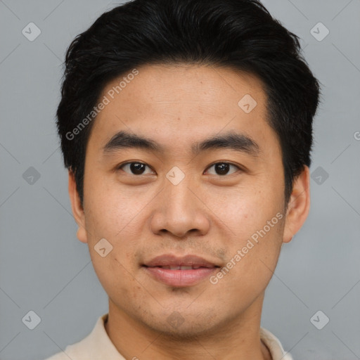 Joyful asian young-adult male with short  black hair and brown eyes