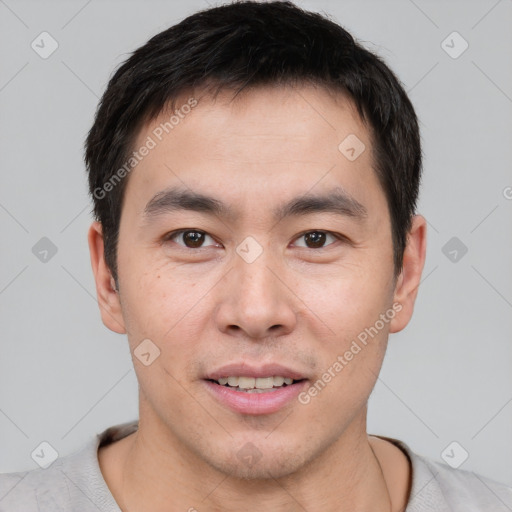 Joyful asian young-adult male with short  brown hair and brown eyes