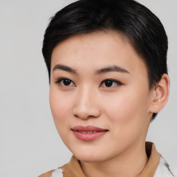 Joyful asian young-adult female with short  black hair and brown eyes