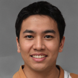 Joyful asian young-adult male with short  black hair and brown eyes