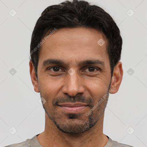 Joyful latino young-adult male with short  black hair and brown eyes