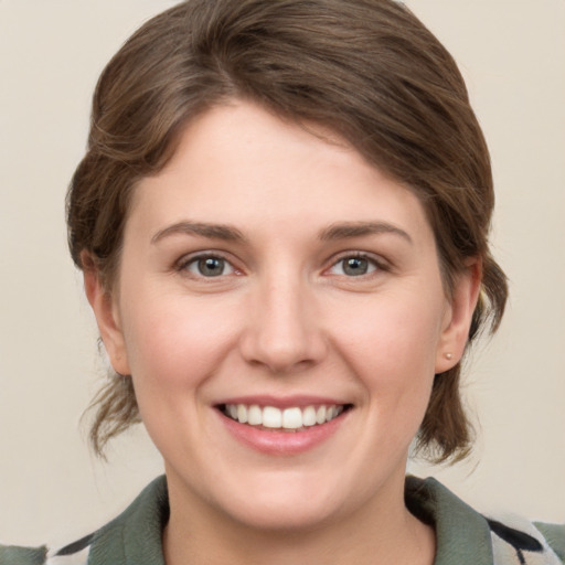 Joyful white young-adult female with medium  brown hair and grey eyes