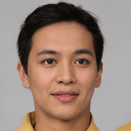 Joyful latino young-adult male with short  brown hair and brown eyes