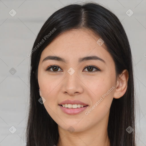 Joyful asian young-adult female with long  brown hair and brown eyes