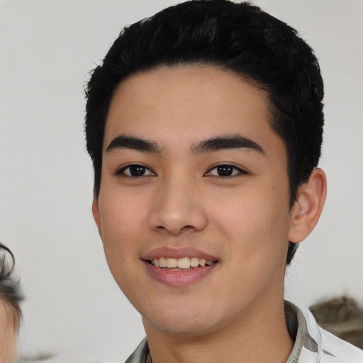 Joyful asian young-adult male with short  black hair and brown eyes