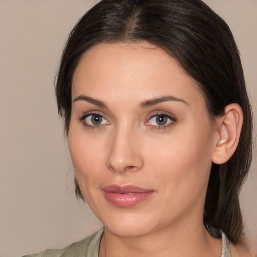 Joyful white young-adult female with medium  brown hair and brown eyes