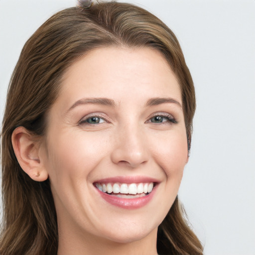 Joyful white young-adult female with long  brown hair and grey eyes