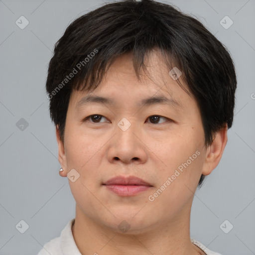 Joyful asian adult male with short  brown hair and brown eyes