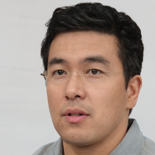 Neutral asian young-adult male with short  black hair and brown eyes