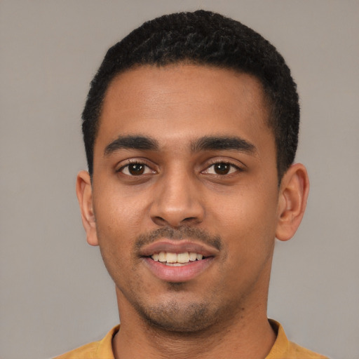 Joyful latino young-adult male with short  black hair and brown eyes