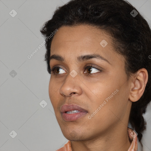 Joyful black young-adult female with short  black hair and brown eyes