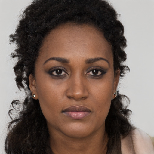 Neutral black young-adult female with long  brown hair and brown eyes