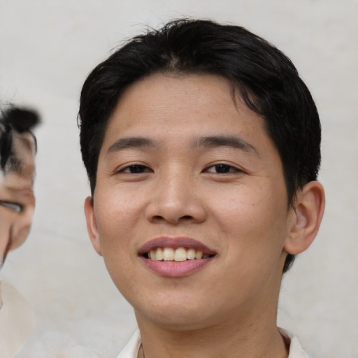 Joyful asian young-adult male with short  black hair and brown eyes