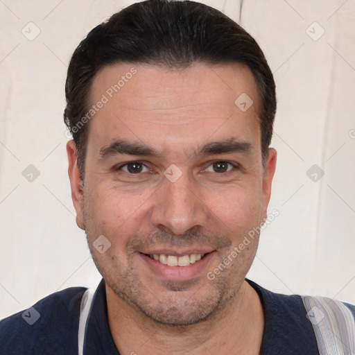 Joyful white adult male with short  black hair and brown eyes