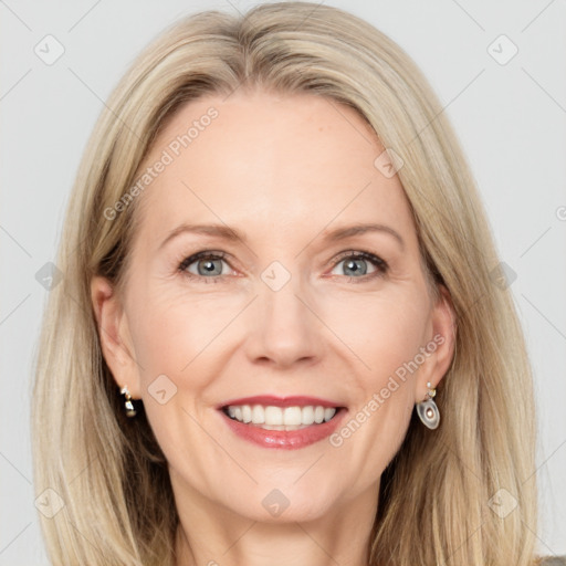 Joyful white adult female with long  brown hair and blue eyes