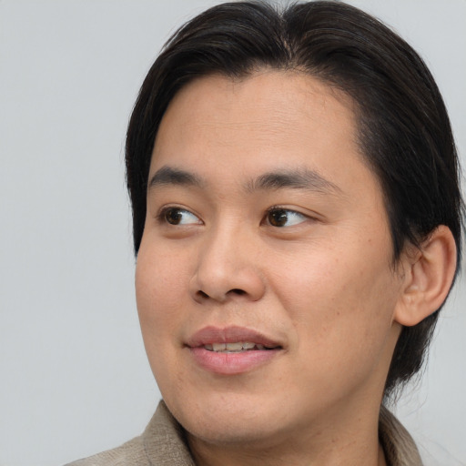 Joyful asian young-adult male with medium  brown hair and brown eyes