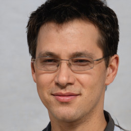 Joyful white adult male with short  brown hair and brown eyes