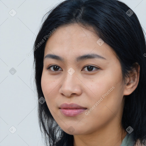 Joyful latino young-adult female with long  black hair and brown eyes