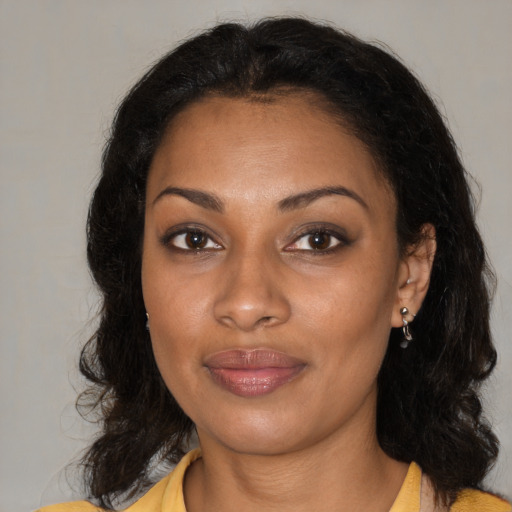 Joyful black young-adult female with medium  brown hair and brown eyes