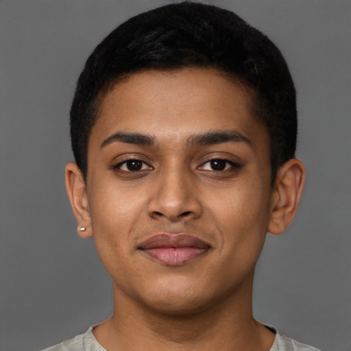 Joyful latino young-adult male with short  brown hair and brown eyes