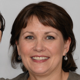 Joyful white adult female with medium  brown hair and brown eyes